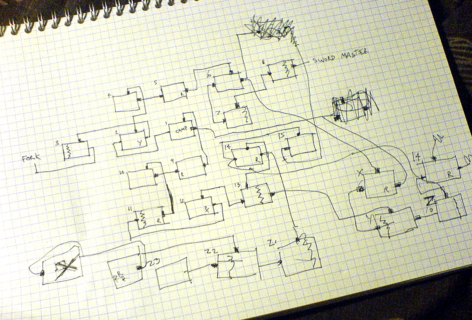 A spiral graph-paper notebook covered in hand-drawn pencil boxes, numbered rooms and connecting lines: a player's map of a video game, made by hand while playing.